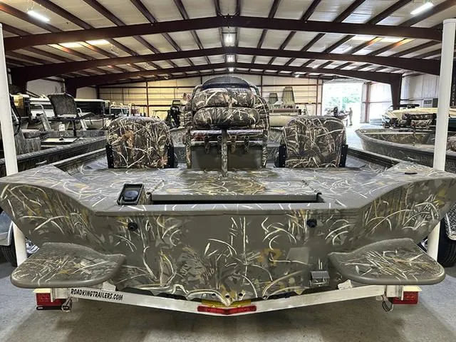 Slide: The Image of 2025 War Eagle 2170 Blackhawk CC boat with camouflage design in a warehouse setting. - 11