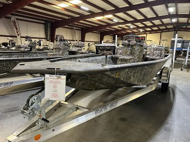 Slide: The Image of 2025 War Eagle 2170 Blackhawk CC boat on display in a showroom. - 3