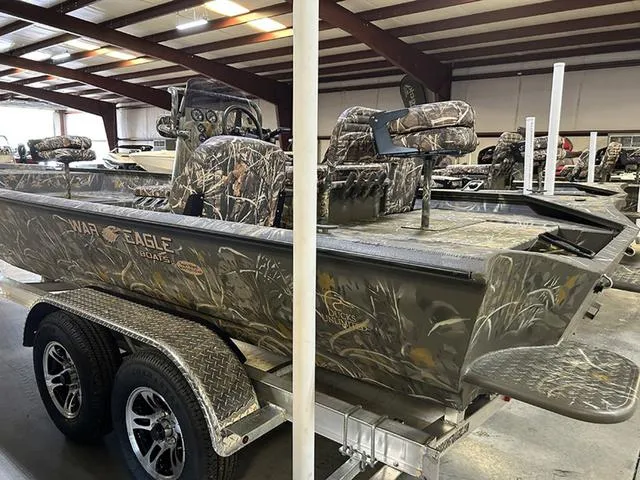 Slide: The Image of 2025 War Eagle 2170 Blackhawk CC boat with camouflage design in a showroom. - 7