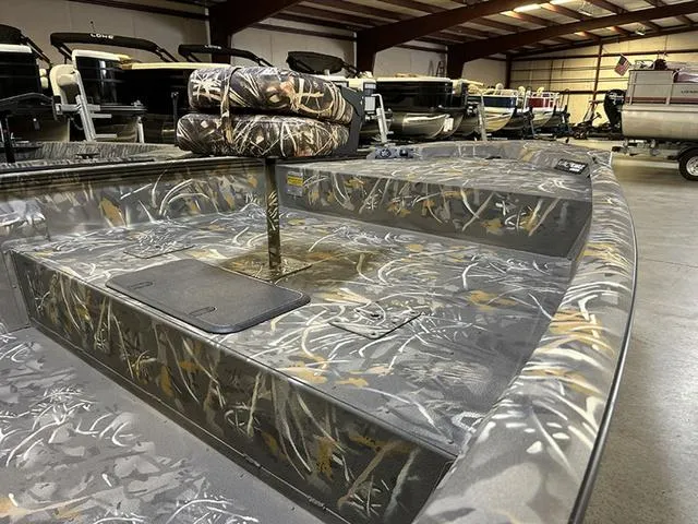 Slide: The Image of 2025 War Eagle 2170 Blackhawk CC boat with camouflage interior in a showroom. - 9