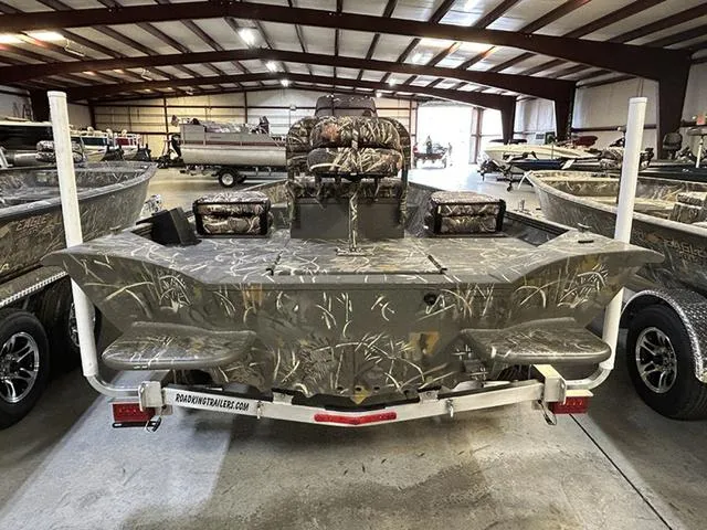 Slide: The Image of 2025 War Eagle 961 Blackhawk CC boat in showroom, featuring camouflage design and trailer. - 11