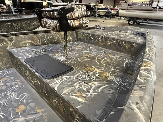 Slide: The Image of 2025 War Eagle 961 Blackhawk CC boat with camouflage design in a showroom. - 6