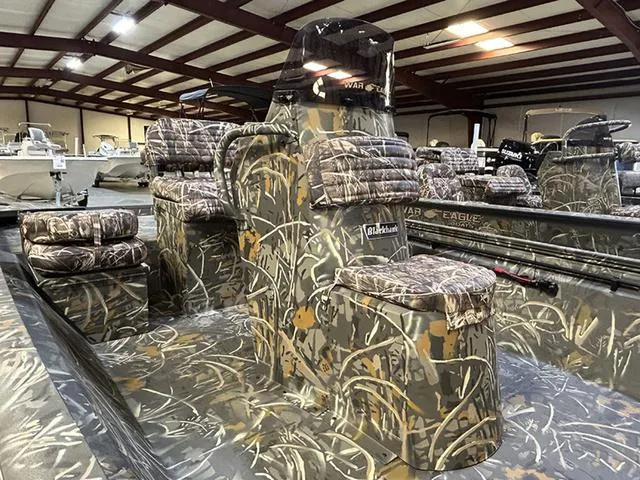 Slide: The Image of 2025 War Eagle 961 Blackhawk CC boat with camouflage design in a showroom. - 7