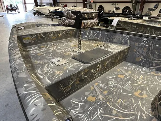 Slide: The Image of 2025 War Eagle 961 Blackhawk CC boat with camouflage interior in a showroom. - 9
