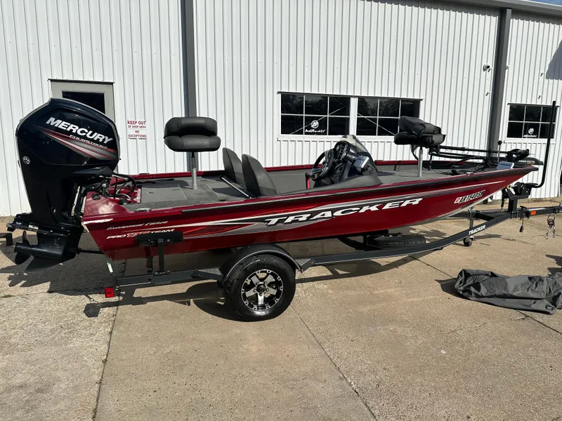 Slide: The Image of 2019 Tracker Pro Team 175 TXW Tournament Edition boat with Mercury engine, parked outdoors. - 2