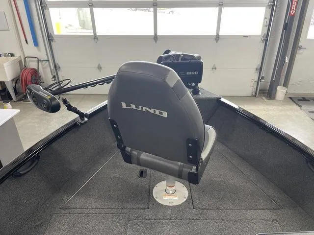 Slide: The Image of 2021 Lund 1650 Rebel XL SS boat interior with swivel seat and trolling motor. - 15
