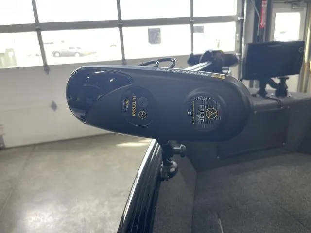 Slide: The Image of 2021 Lund 1650 Rebel XL SS boat with Minn Kota trolling motor in a garage setting. - 19