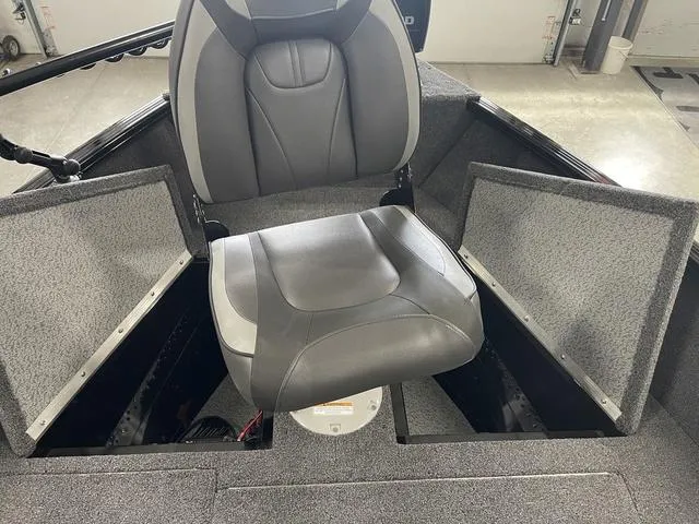 Slide: The Image of 2021 Lund 1650 Rebel XL SS boat interior with gray seating and storage compartments. - 20