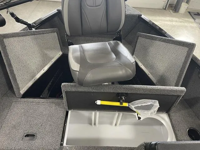 Slide: The Image of 2021 Lund 1650 Rebel XL SS boat interior with seating and storage compartments. - 21