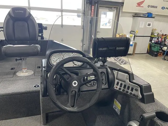 Slide: The Image of 2021 Lund 1650 Rebel XL SS boat interior with steering wheel and Humminbird fish finder. - 22