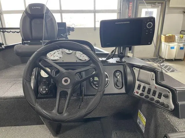 Slide: The Image of 2021 Lund 1650 Rebel XL SS boat dashboard with steering wheel and navigation system. - 24