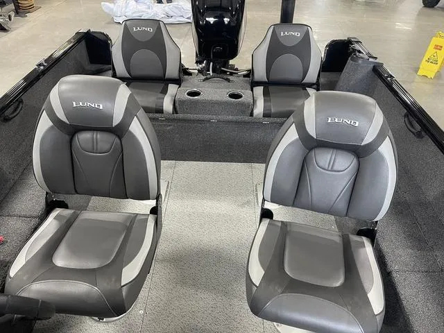 Slide: The Image of 2021 Lund 1650 Rebel XL SS boat interior with four gray seats and cup holders. - 26