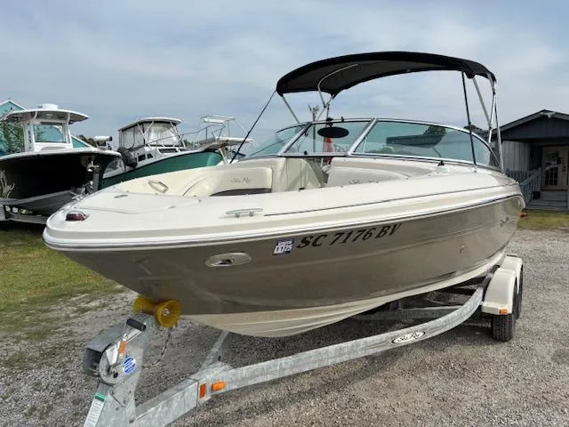 Slide: The Image of 2006 Sea Ray 200 Select boat on trailer, parked outdoors, with canopy and registration number visible. - 1