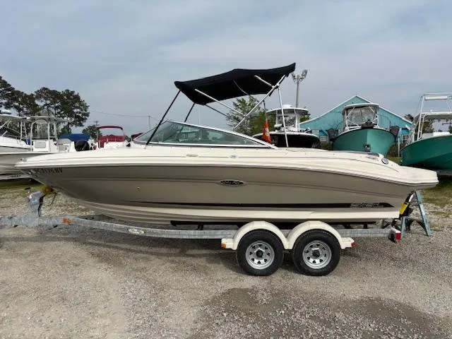 Slide: The Image of 2006 Sea Ray 200 Select boat on trailer, parked outdoors with canopy. - 11
