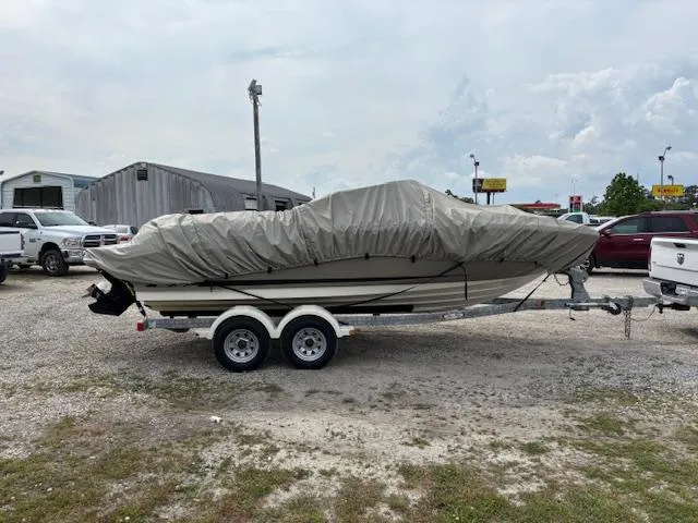 Slide: The Image of 2006 Sea Ray 200 Select boat covered on a trailer in a parking lot. - 13
