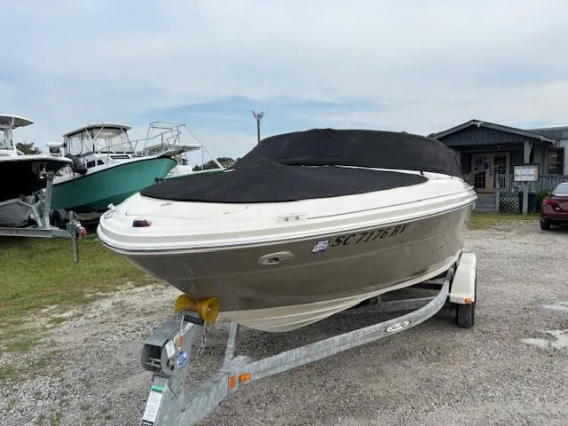 Slide: The Image of 2006 Sea Ray 200 Select boat on trailer, covered, parked outdoors. - 15