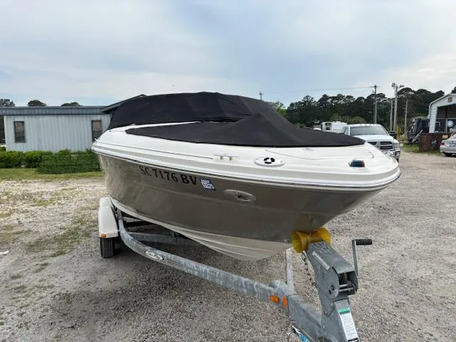 Slide: The Image of 2006 Sea Ray 200 Select boat on trailer with black cover, parked outdoors. - 16