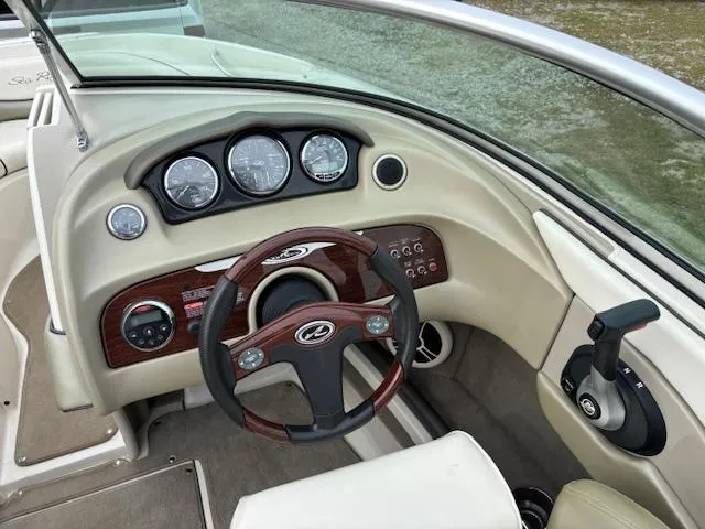 Slide: The Image of 2006 Sea Ray 200 Select boat dashboard with steering wheel and control panel. - 17
