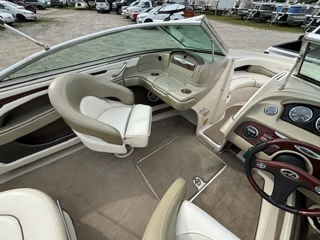 Slide: The Image of 2006 Sea Ray 200 Select boat interior with beige seating and dashboard controls. - 19