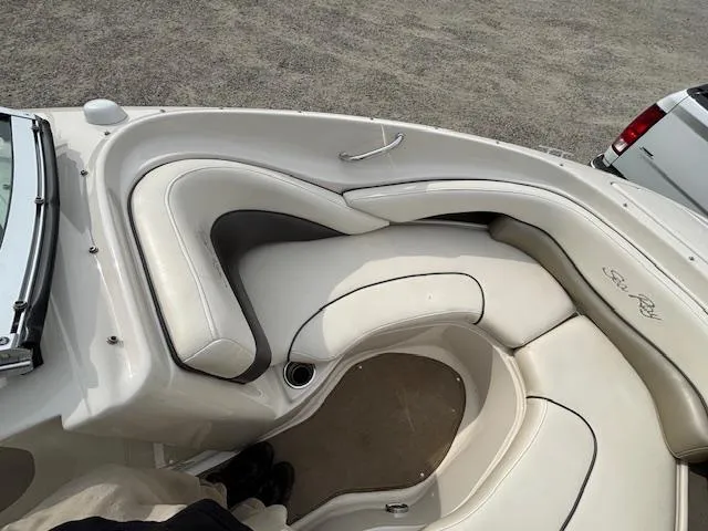 Slide: The Image of 2006 Sea Ray 200 Select boat interior with white cushioned seating. - 23