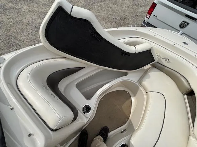Slide: The Image of 2006 Sea Ray 200 Select boat interior with white seating and storage compartments. - 32