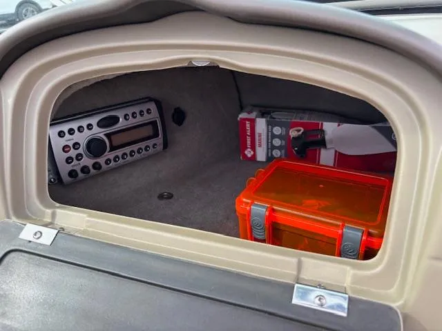 Slide: The Image of Glove compartment of 2006 Sea Ray 200 Select with radio and safety gear. - 34