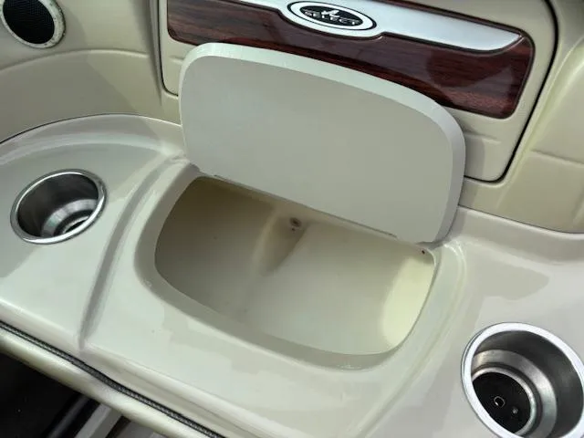 Slide: The Image of 2006 Sea Ray 200 Select boat interior with cup holders and storage compartment. - 35