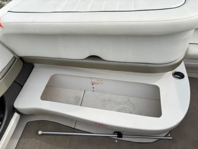 Slide: The Image of 2006 Sea Ray 200 Select boat interior storage compartment with white cushioned seating. - 37