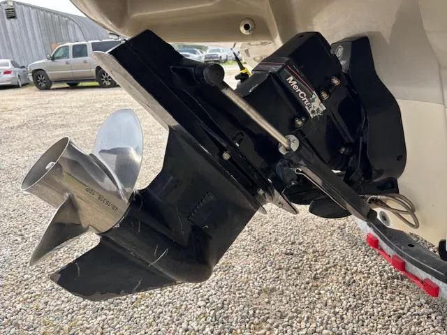 Slide: The Image of 2006 Sea Ray 200 Select boat propeller and outdrive in a gravel lot. - 39