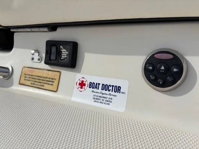 Slide: The Image of 2006 Sea Ray 200 Select boat dashboard with Boat Doctor service sticker and control panel. - 42