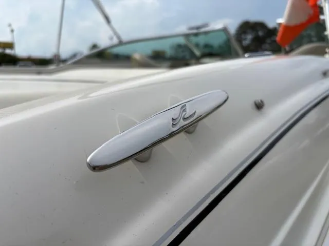 Slide: The Image of 2006 Sea Ray 200 Select boat emblem on white hull, close-up view. - 45