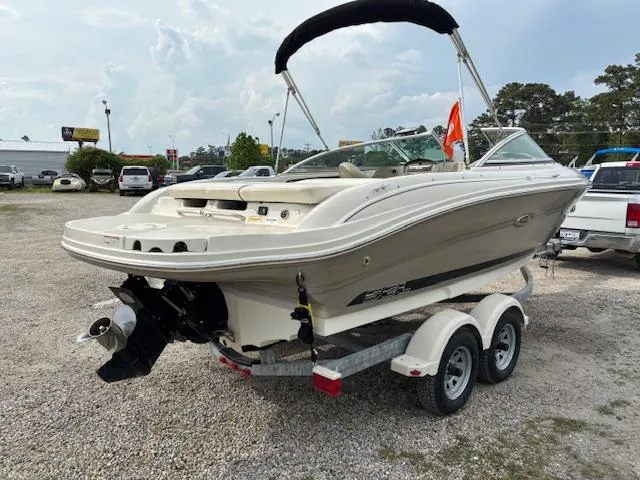 Slide: The Image of 2006 Sea Ray 200 Select boat on trailer, parked outdoors, with a bimini top. - 6