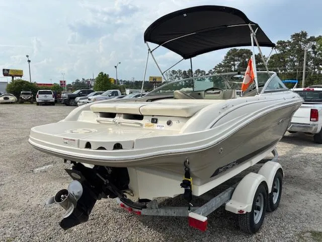 Slide: The Image of 2006 Sea Ray 200 Select boat on trailer, parked outdoors with canopy. - 7
