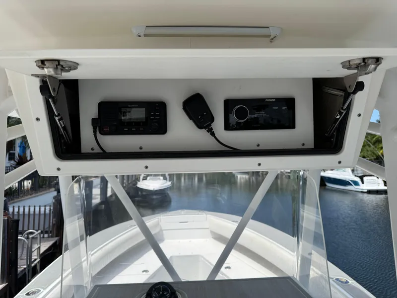 Slide: The Image of 2005 Regulator 23 Center Console boat dashboard with radio and microphone. - 12