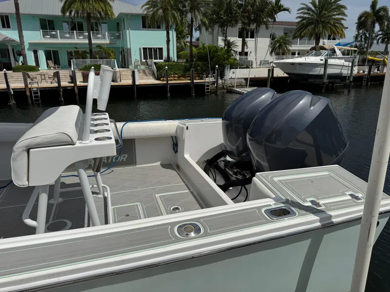 Slide: The Image of 2005 Regulator 23 Center Console boat with dual engines docked by waterfront homes. - 20