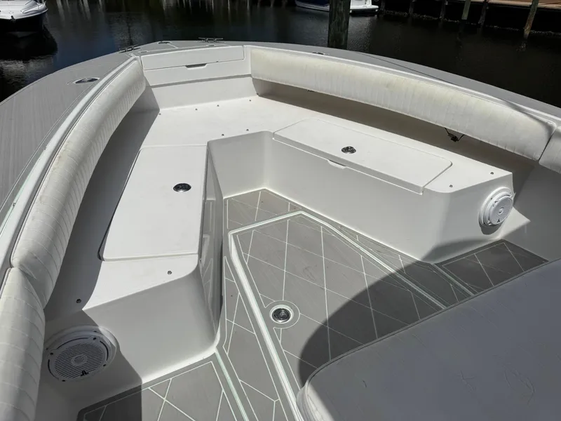 Slide: The Image of 2005 Regulator 23 Center Console boat interior with cushioned seating and storage compartments. - 7