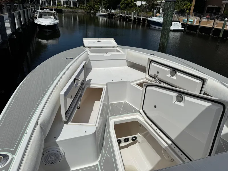 Slide: The Image of 2005 Regulator 23 Center Console boat with open storage compartments, docked in a marina. - 8