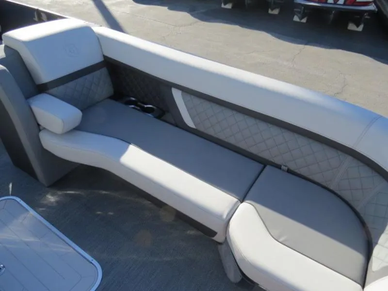 Slide: The Image of Luxurious seating on 2023 Godfrey AquaPatio 255 ULC pontoon boat, featuring elegant quilted upholstery. - 2