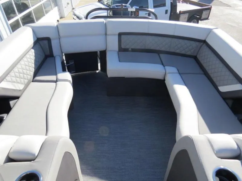 Slide: The Image of 2023 Godfrey AquaPatio 255 ULC boat interior with spacious seating and modern design. - 7
