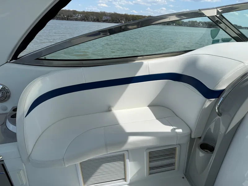 Slide: The Image of 2011 Formula 340PC boat interior with white seating and blue accent, overlooking water. - 13