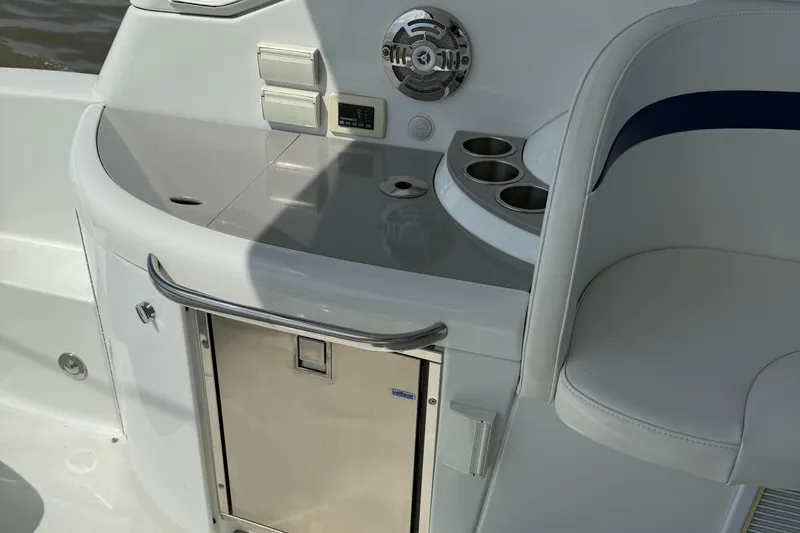 Slide: The Image of 2011 Formula 340PC boat interior with sink, cup holders, and storage compartment. - 17