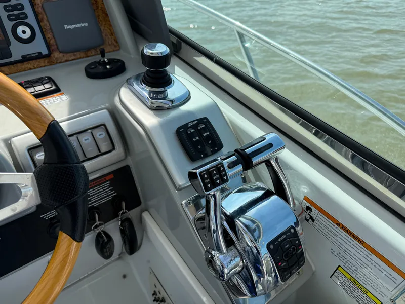 Slide: The Image of Control panel of a 2011 Formula 340PC boat with steering wheel and throttle levers. - 3