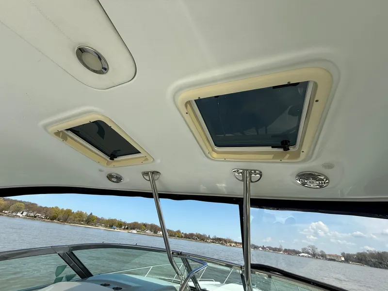 Slide: The Image of Interior view of 2011 Formula 340PC boat with open hatches and scenic water backdrop. - 5