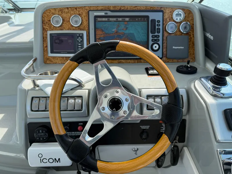 Slide: The Image of Steering wheel and navigation controls of a 2011 Formula 340PC boat. - 8