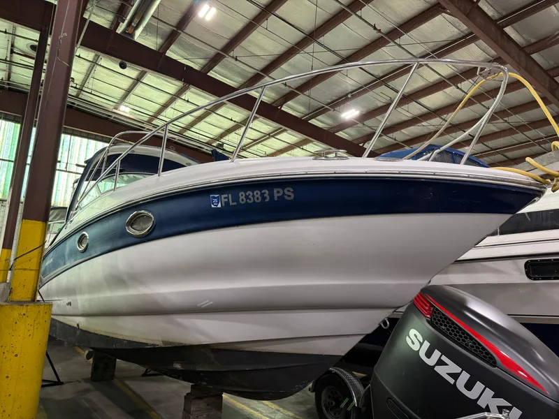 The Image of 2007 Crownline 250 CR boat in storage, featuring a blue and white hull. - 0