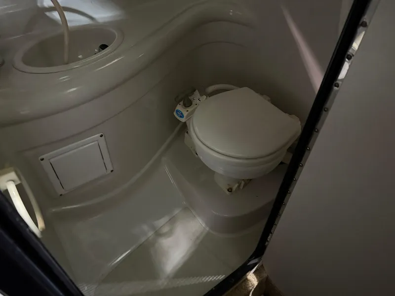 Slide: The Image of 2007 Crownline 250 CR boat bathroom with toilet and sink. - 13