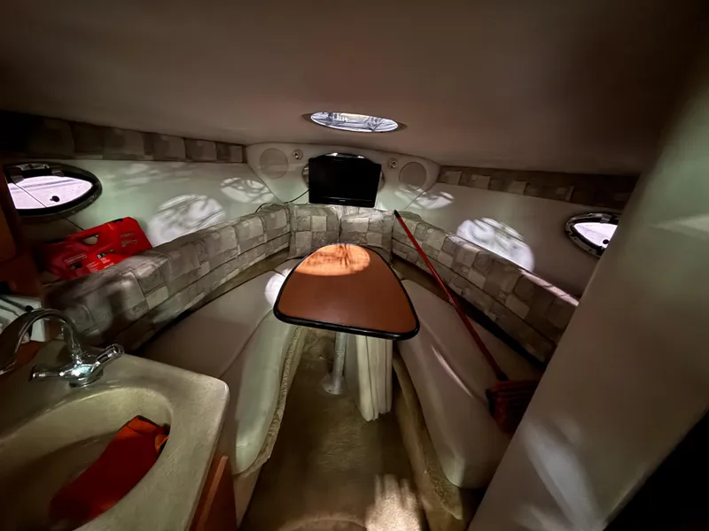 Slide: The Image of Interior of 2007 Crownline 250 CR boat with seating, table, and sink. - 14