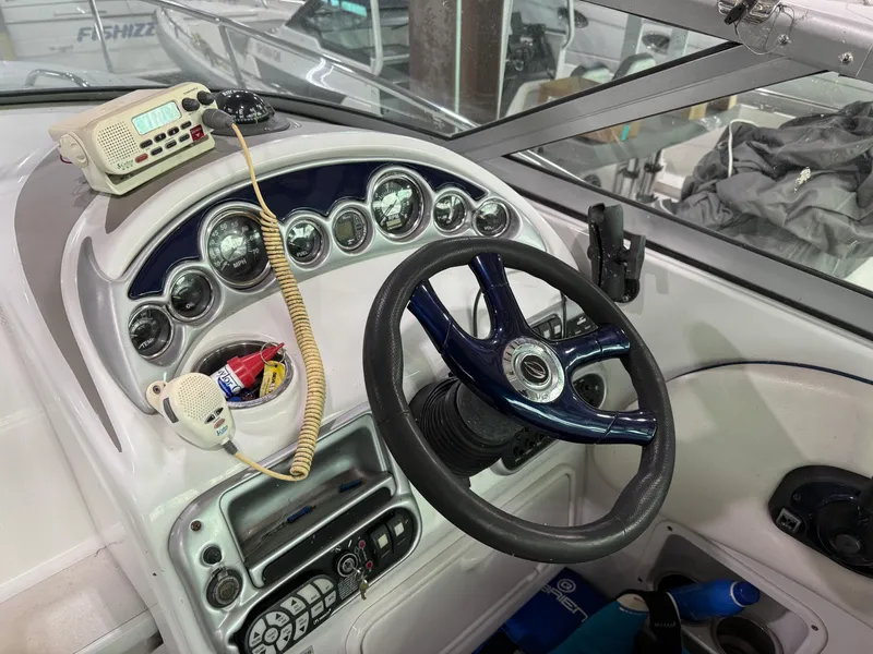Slide: The Image of 2007 Crownline 250 CR boat dashboard with steering wheel and control panel. - 6