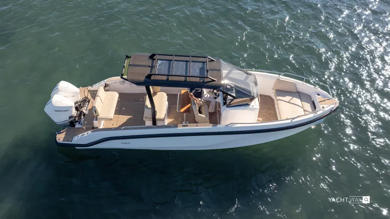 Slide: The Image of 2025 Rand Roamer boat cruising on clear water, featuring sleek design and modern amenities. - 14