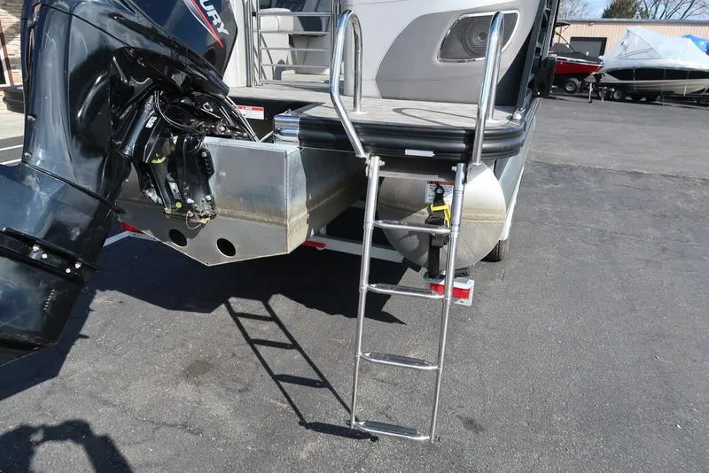 Slide: The Image of 2021 Bennington R Bowrider Quad Bench 24 RTFB with ladder and outboard motor. - 22